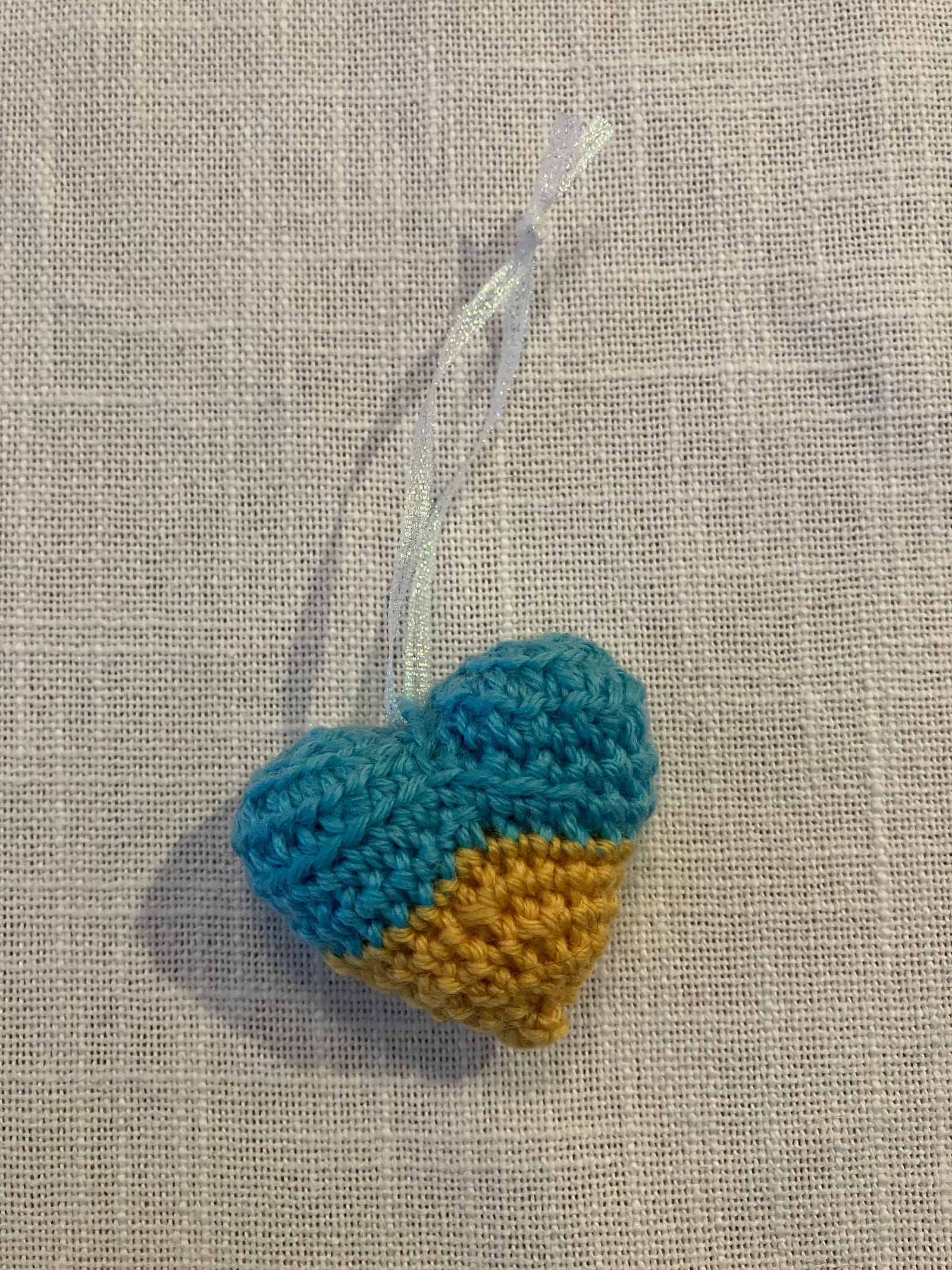 Small crocheted heart in the colors of the Ukrainian flag