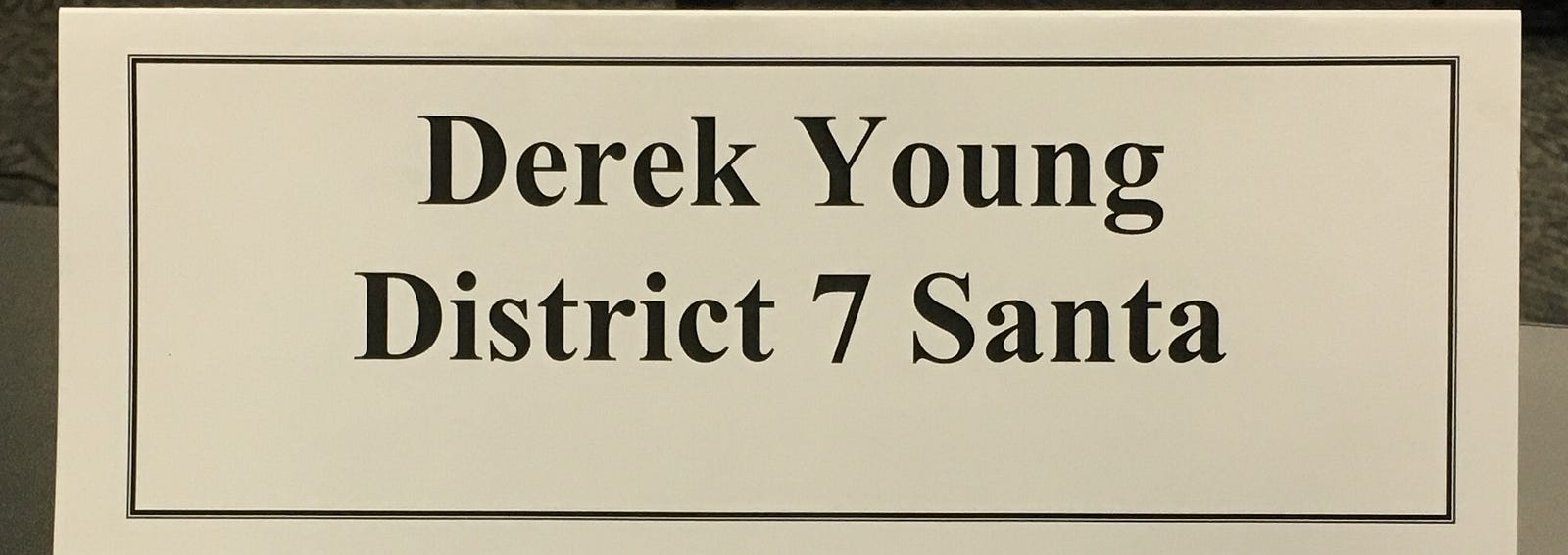 Nameplate saying: "Derek Young, District 7 Santa."