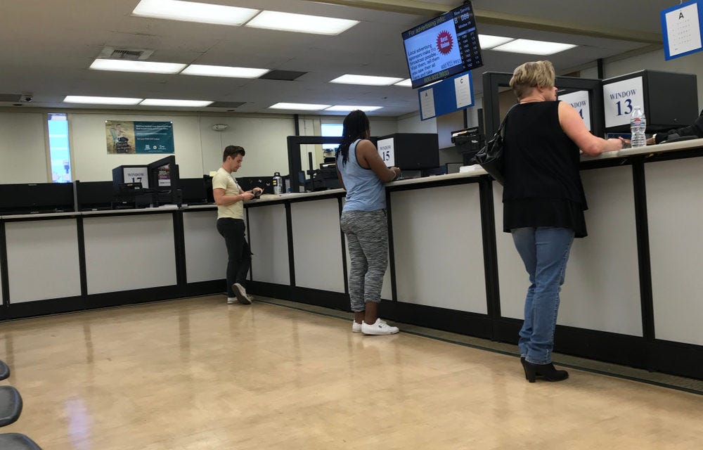state issued ID card application state id card application form being filled by applicant at DMV counter