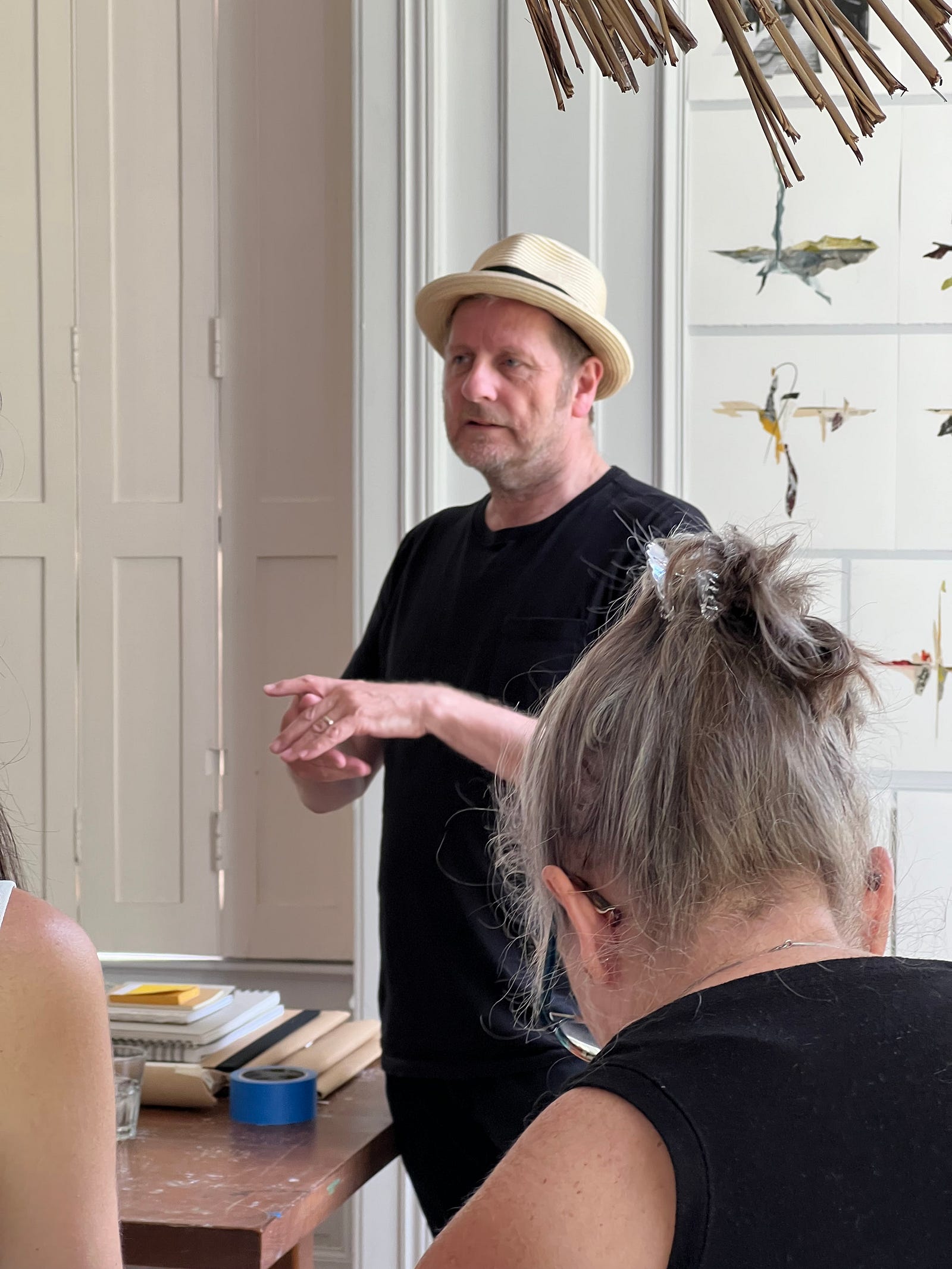 Photo of Artist-in-Residence Clive Knights telling the story of his art during an open studio session at Chateau Orquevaux, France