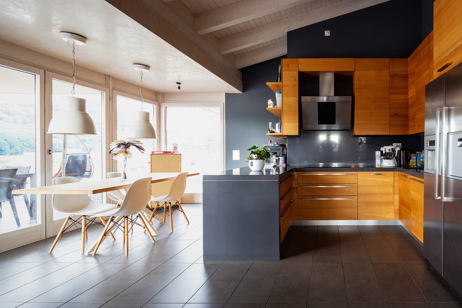 Modern kitchen with wooden pannels and a white table and chair set