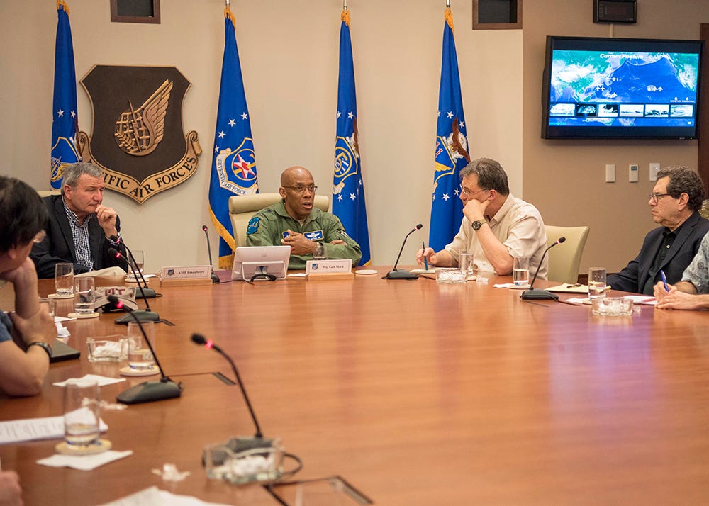general speaks at a table