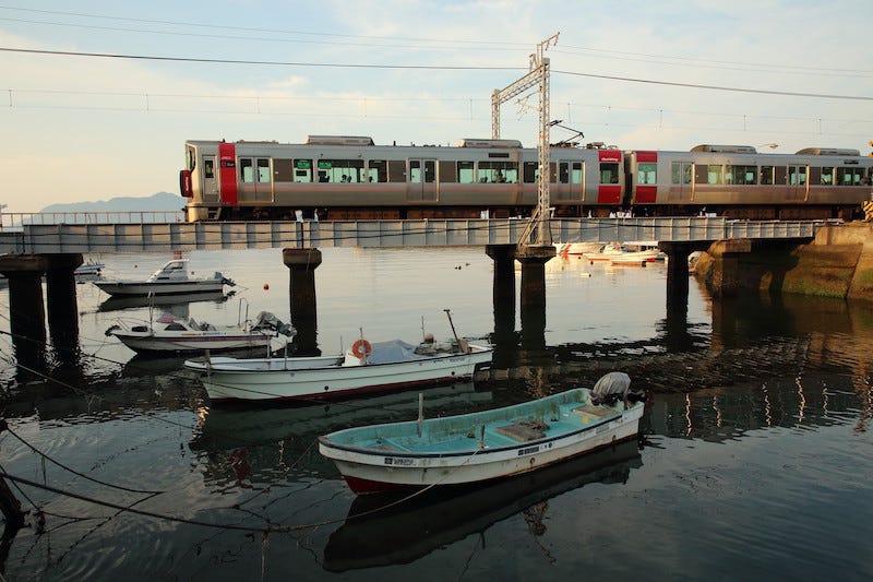 A train passes over a bridge while en route to Kure on the JR Kure Line