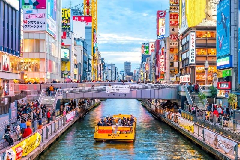 A boat cruises along the ever-popular Dotonbori River in central Osaka