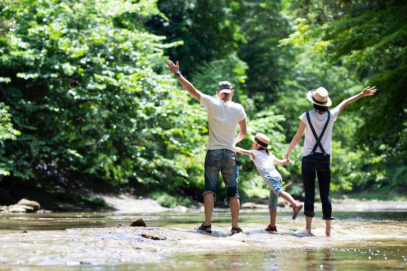 A family in Tokyo plays together by the river in Okutama in an attempt to escape the heat
