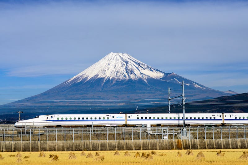 A bullet train zooms past Mt. Fuji during spring en route to Shimane Prefecture