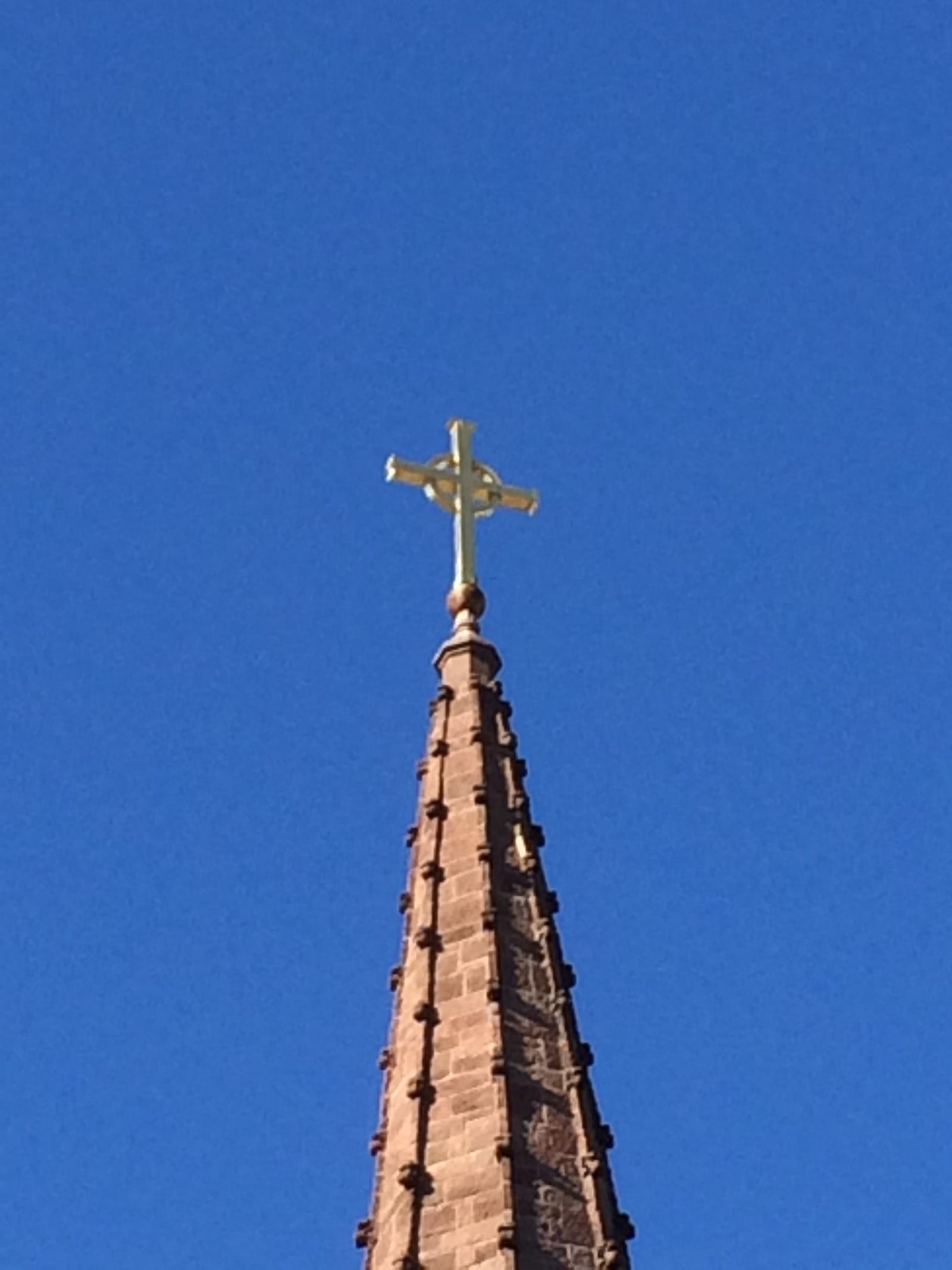 Photo of the cross atop the steeple at St. James Episcopal Church, New London, CT on a perfectly blue and cloudless fall day. Photo by Ron Steed