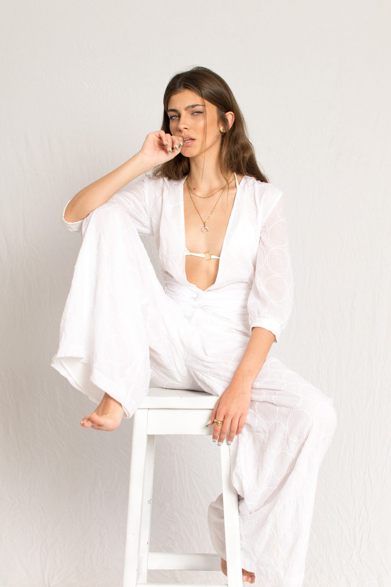 White plunging neckline beachwear jumpsuit with sleeves and waist knot details