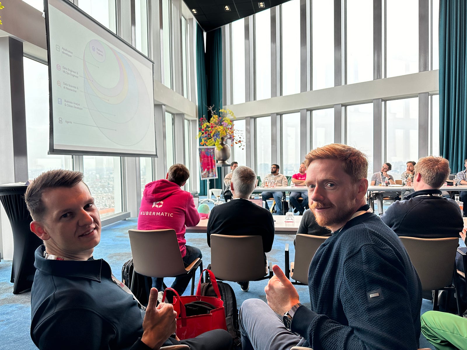 Two men sitting at a table during a meeting about platform engineering and digital sovereignty.