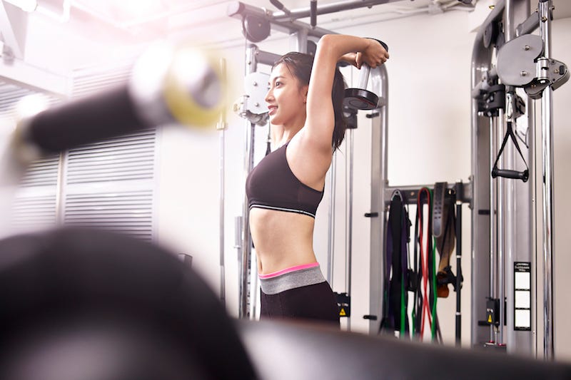 A woman works out while traveling in Japan at a public facility owned by the ward she is staying in