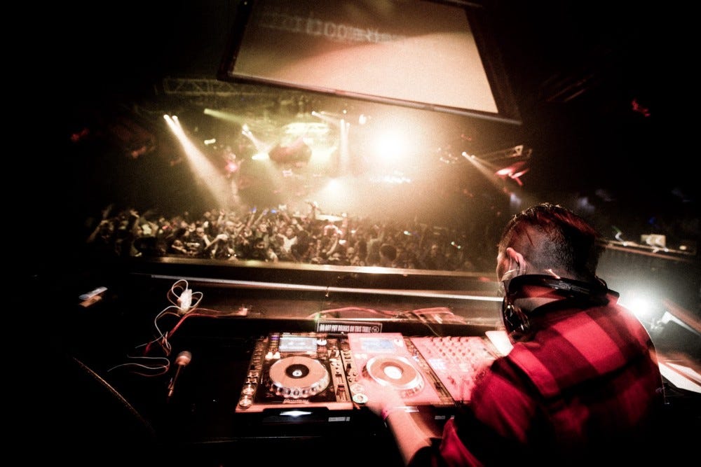 A DJ by the name of Tha Boogie Bandit plays electronic dance music at ageHa, a club that was once the biggest in Tokyo