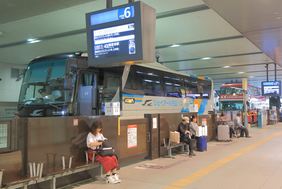 People wait to board one of Japna’s highway buses
