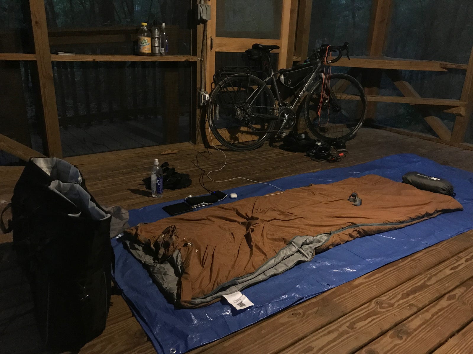 Sleeping bag in the Holton Creek River Camp platform - the wood floors were even well-sealed, but I set up the tarp as a barrier anyway.