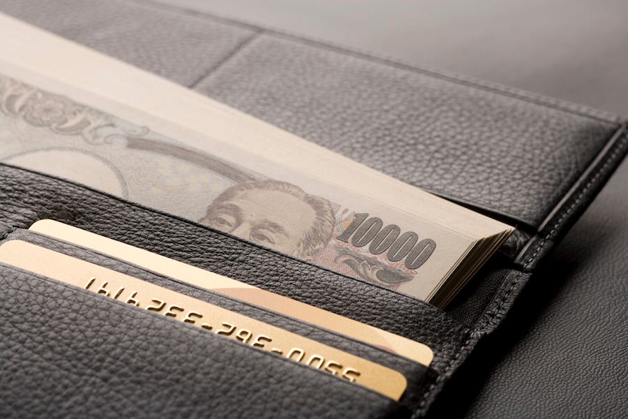 A wallet is stacked with cash in anticipation of a night of partying in Japan