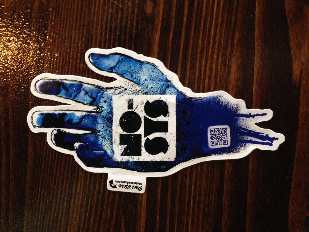 a sticker of a hand with a blue paint on it