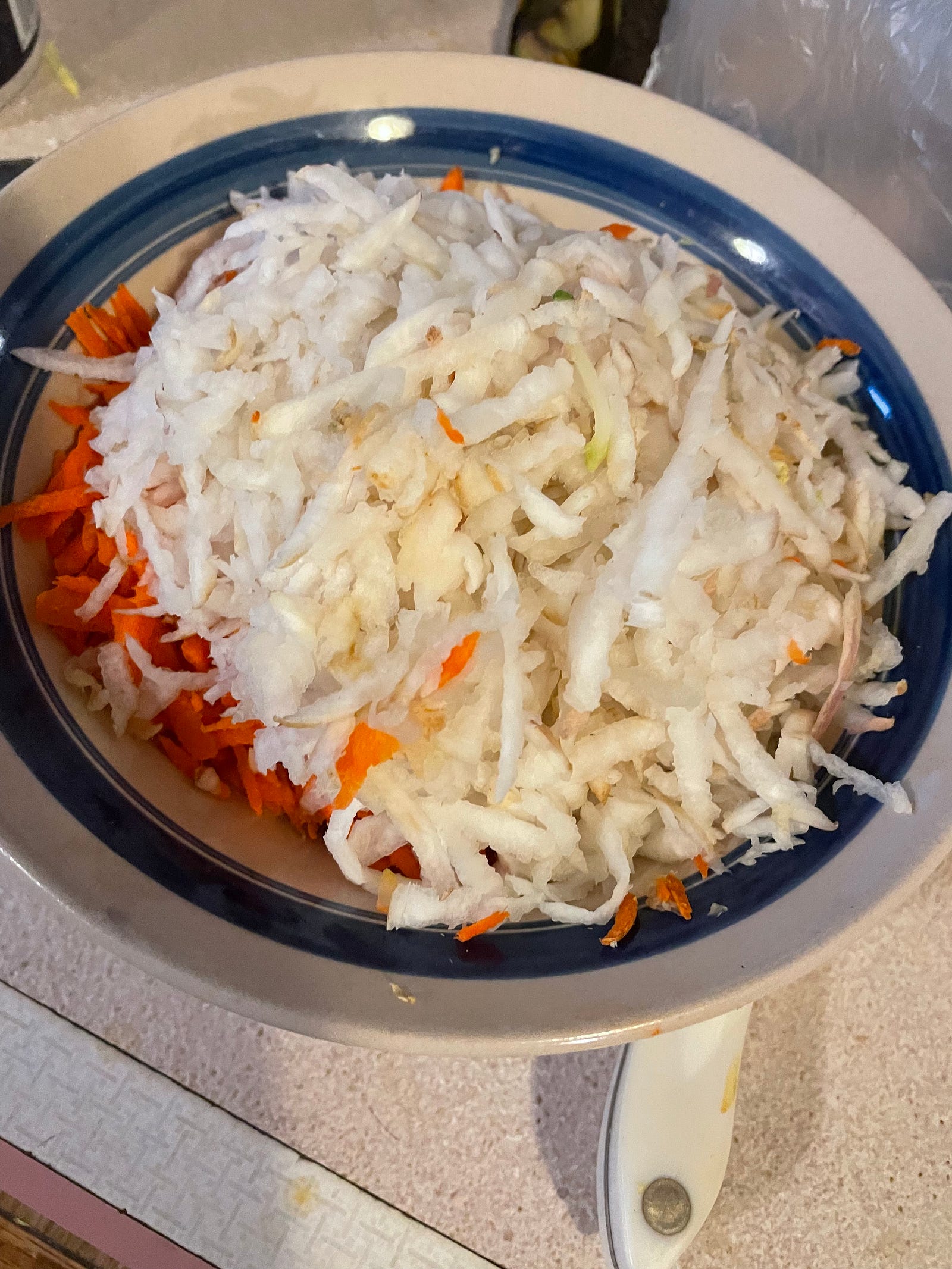 A full bowl of corsely grated root vegables