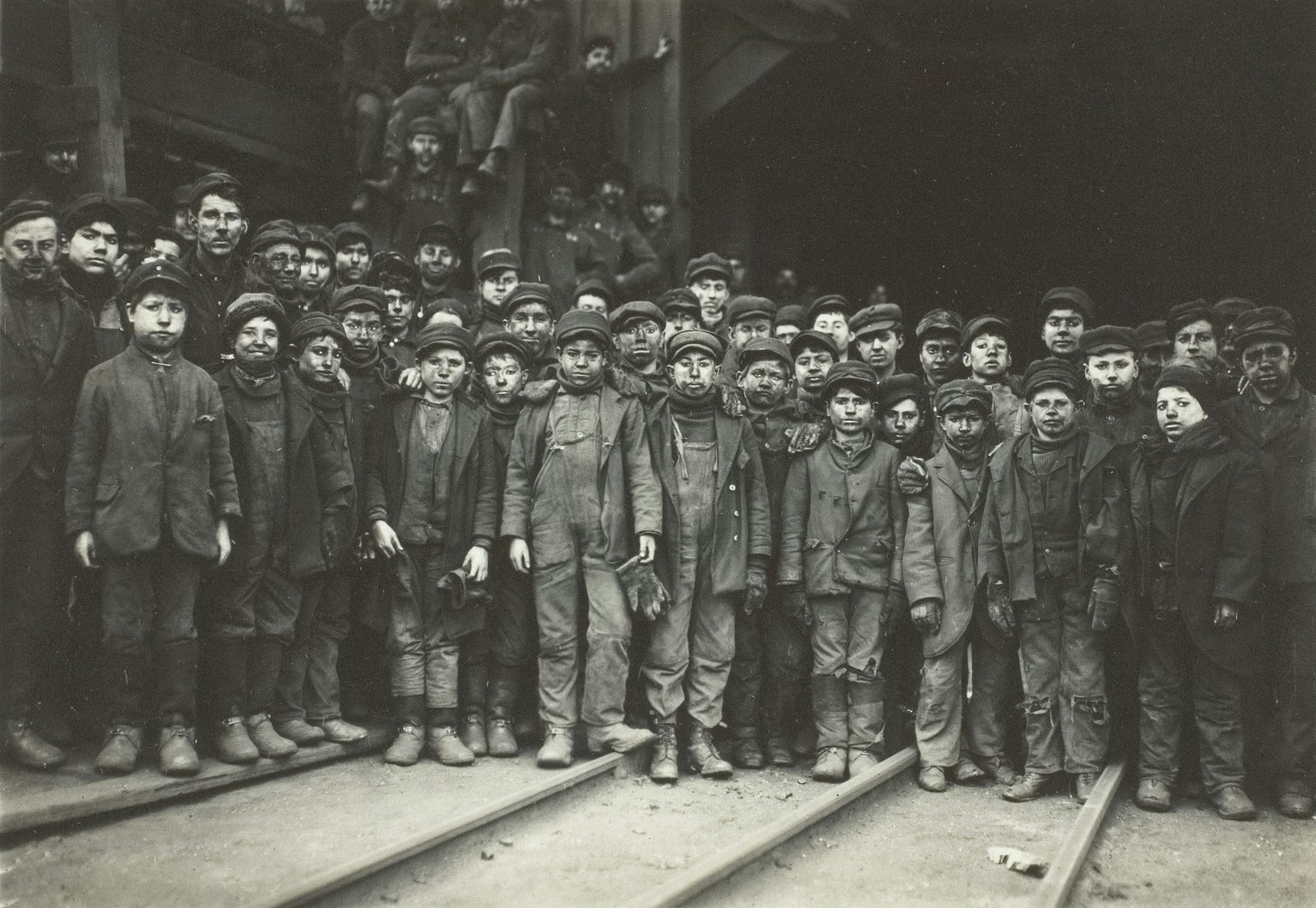 A group of young boys working in a factory, illustrating historical child labour.
