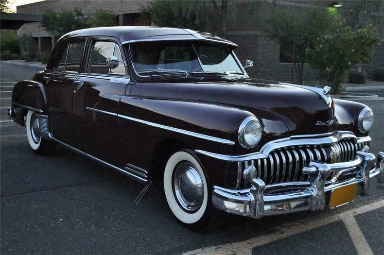 Photograph of a beautifully maintained 1950 DeSoto Custom sedan covered in chrome and with whitewall tires. Biography of Dr. Anthony J. Carbone.