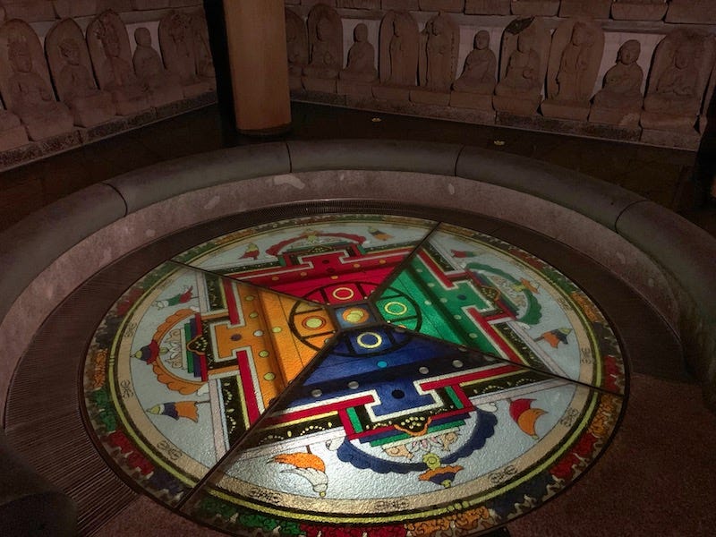 A mandala that’s surrounded by Buddhist statues at Osaka’s Senko-ji