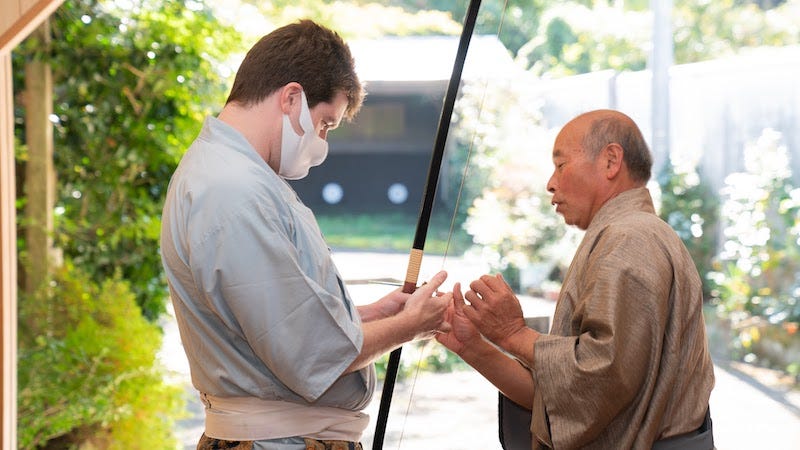 Donny Kimball learns how to shoot a bow used for kyudo in Akizuki, Fukuoka Prefecture