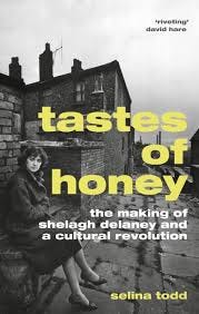 Front cover of Selina Todd’s book ‘tastes of honey’, depicting a woman sat in a backstreet behind some terraced houses.