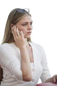 Blond girl with white shirt on the phone