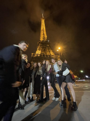 A group of students posed in front of the Eiffel Tower