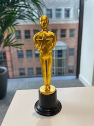 A small gold-coloured statuette of a man holding a star