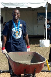 Special Olympics athlete Robert Cooper shows off his gold medal from the 2011 Special Olympics World Summer Games as he assists in the 2012 NBA All-Star Day of Service