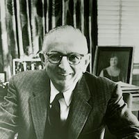 Warren Weaver sitting at his desk.