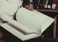 An animated image showing a person flipping through a book