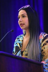 Maria Mejia speaking at an HIV advocacy event.