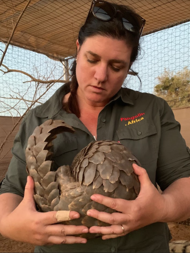 Photo of Helena Atkinson with a pangolin that was taken from the illegal wildlife trade. It is one of the lucky ones that was rescued, treated, and eventually released.