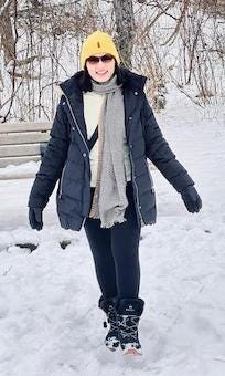 An Indian woman enjoying snowfall.