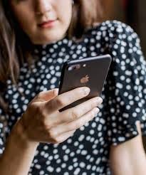 woman holds phone that is too large for her hands