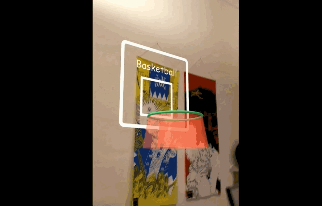 A virtual ball being shot into a virtual basketball hoop.