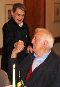 Jean Vanier shaking hands with one of the core members of L'Arche Daybreak, John Smeltzer.