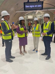 Secretary Buttigieg talks with local transportation leaders and Speaker Pelosi in the new Central Subway station.