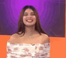 A girl with a floral dress cheering up and smiling and laughing her heart out. she looks bubbly, she has kept her hair open, and she is amking some action. she looks excited. This is a GIF of YAY.