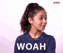 A girl with a blue tshirt and a pony tail making some action with her finger saying Woah. This is a GIF of WOAH.
