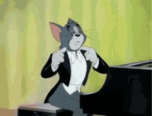 GIF of Tom from Tom and Jerry preparing to play the Piano