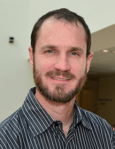 Bearded man in striped shirt