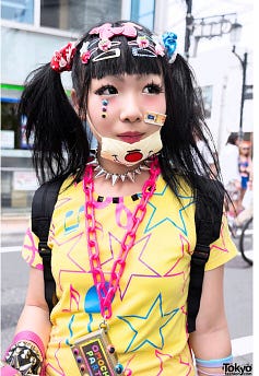 A woman wearing Harajuku style and a face mask with cartoon on her chin.