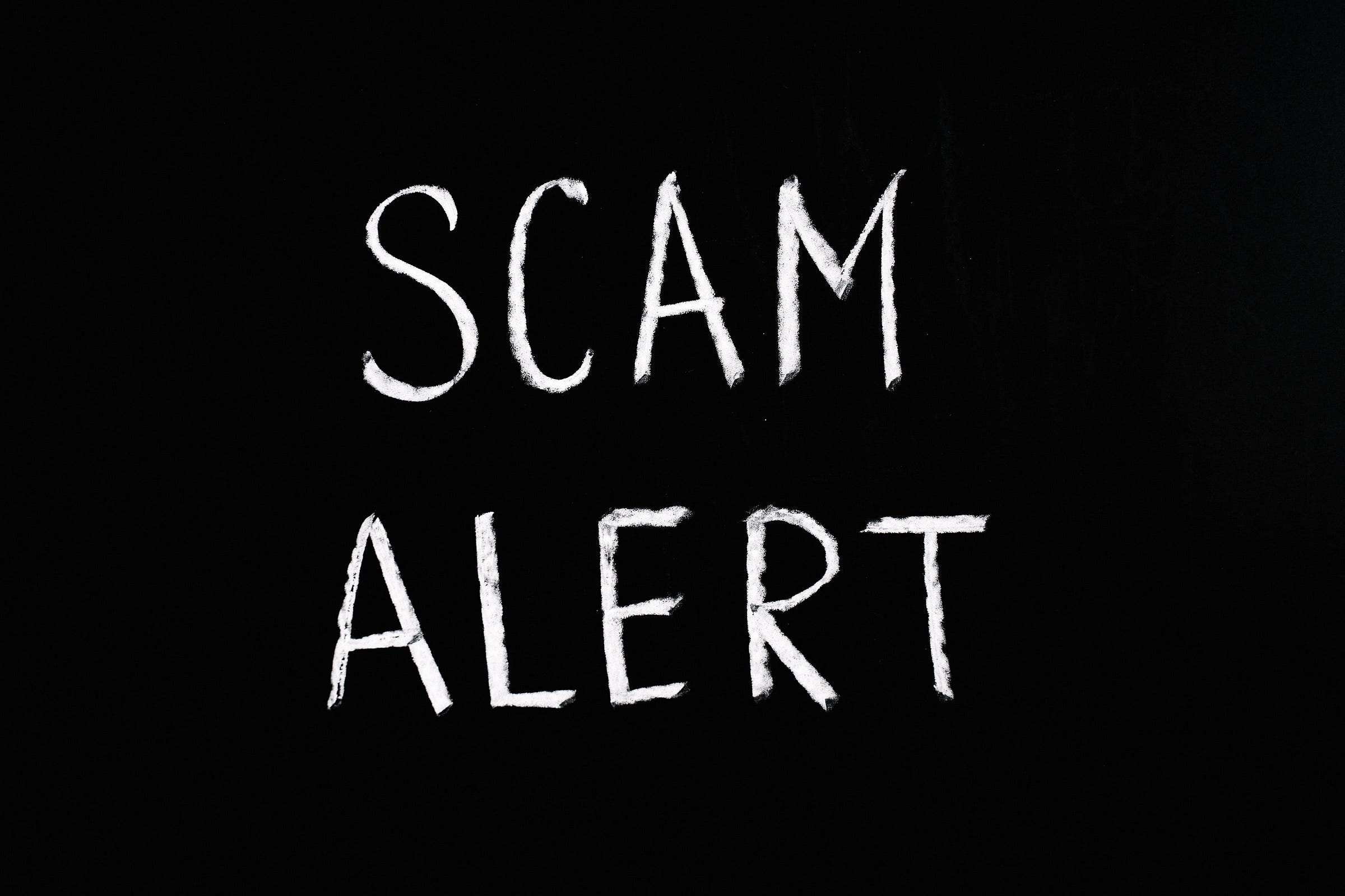 “Scam Alert” written in white on a black background.