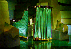 Gif of a scene from Wizard of Oz, in which Toto pulls back the curtain.