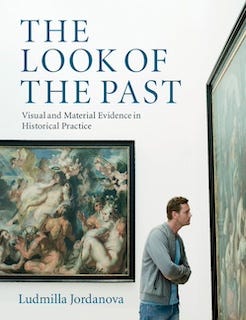 Book cover of Ludmilla Jordanova’s book ‘The Look of the Past’ (2012) showing a man examining closely a large painting, with another large historical-looking painting on the wall behind him giving the sense that the scene takes place in an art gallery.