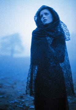 Fashion photo of a model in a foggy landscape.