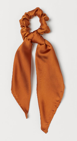 A burnt orange scarf scrunchie.