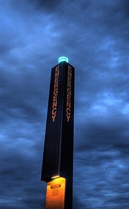 Campus security pole with blue light bulb on top