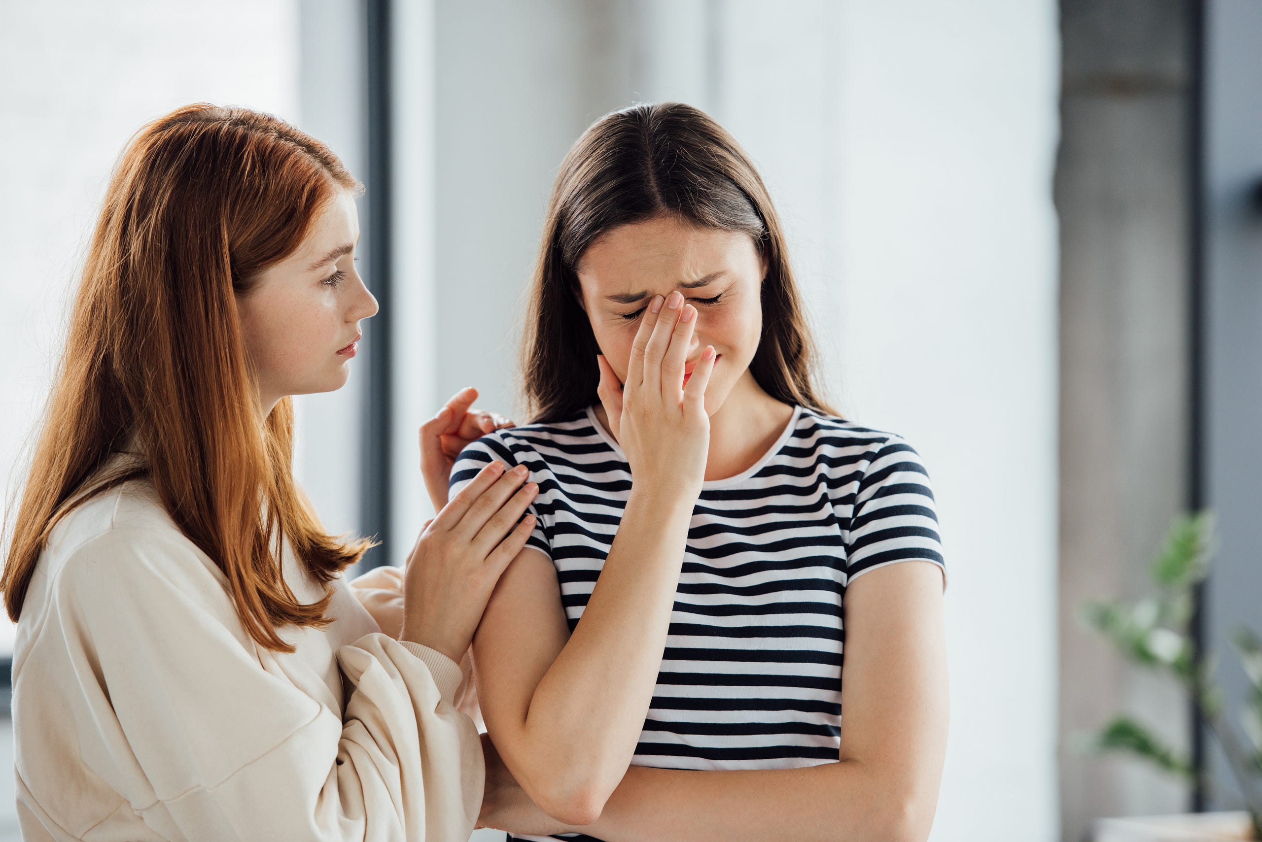 A friend attempts to console someone they love. A friend attempts to console someone they love.